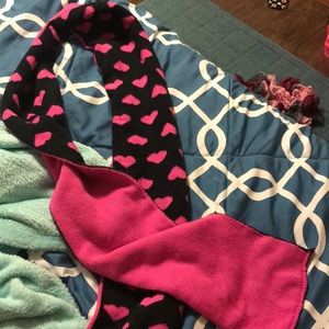 This is a longer scarf that is black with hearts.